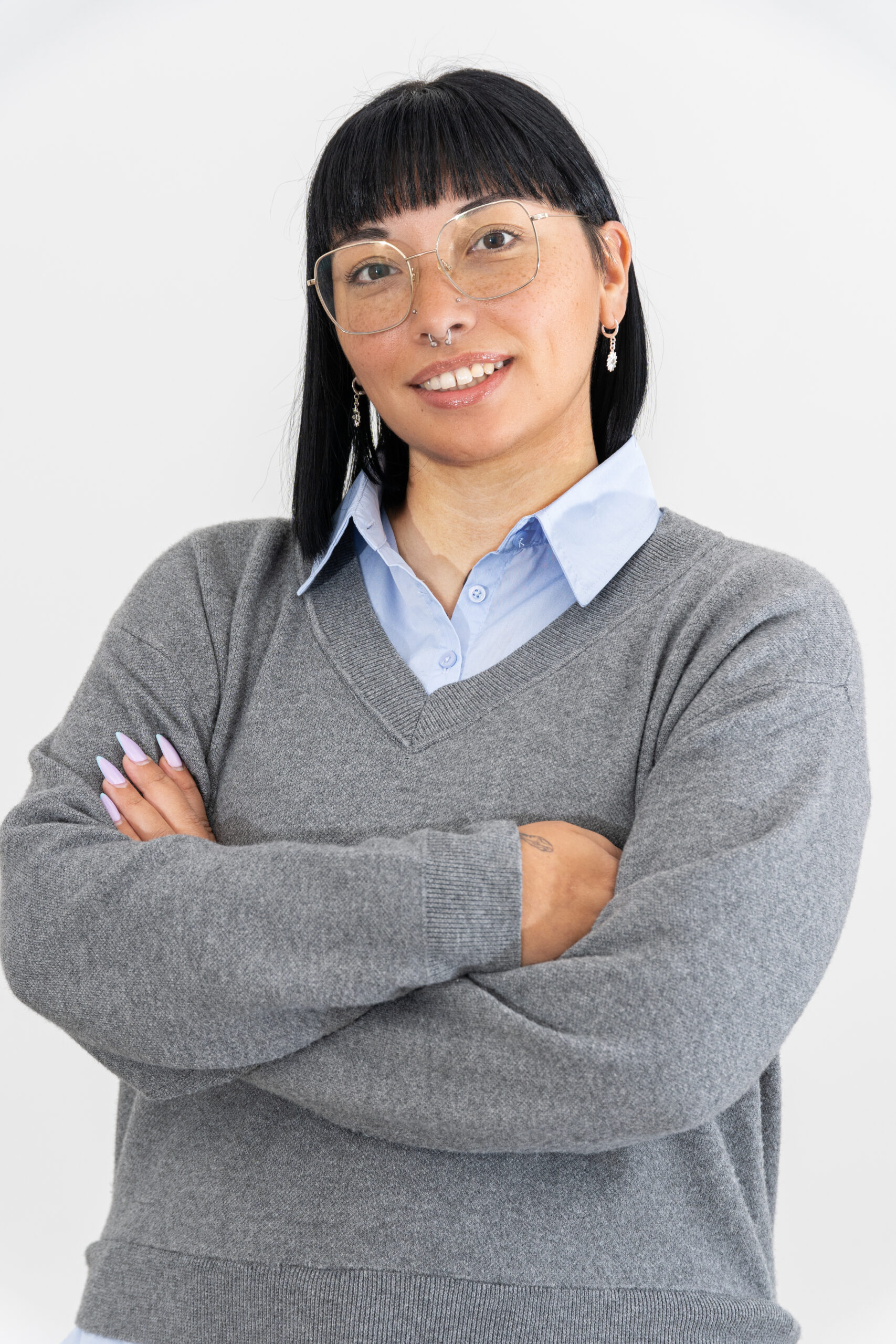a woman with glasses and a sweater